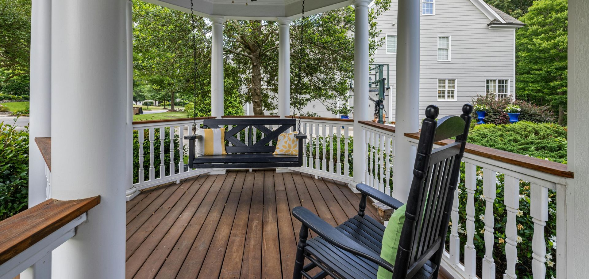 Inviting porch with rocking chair and swing, perfect for relaxation.